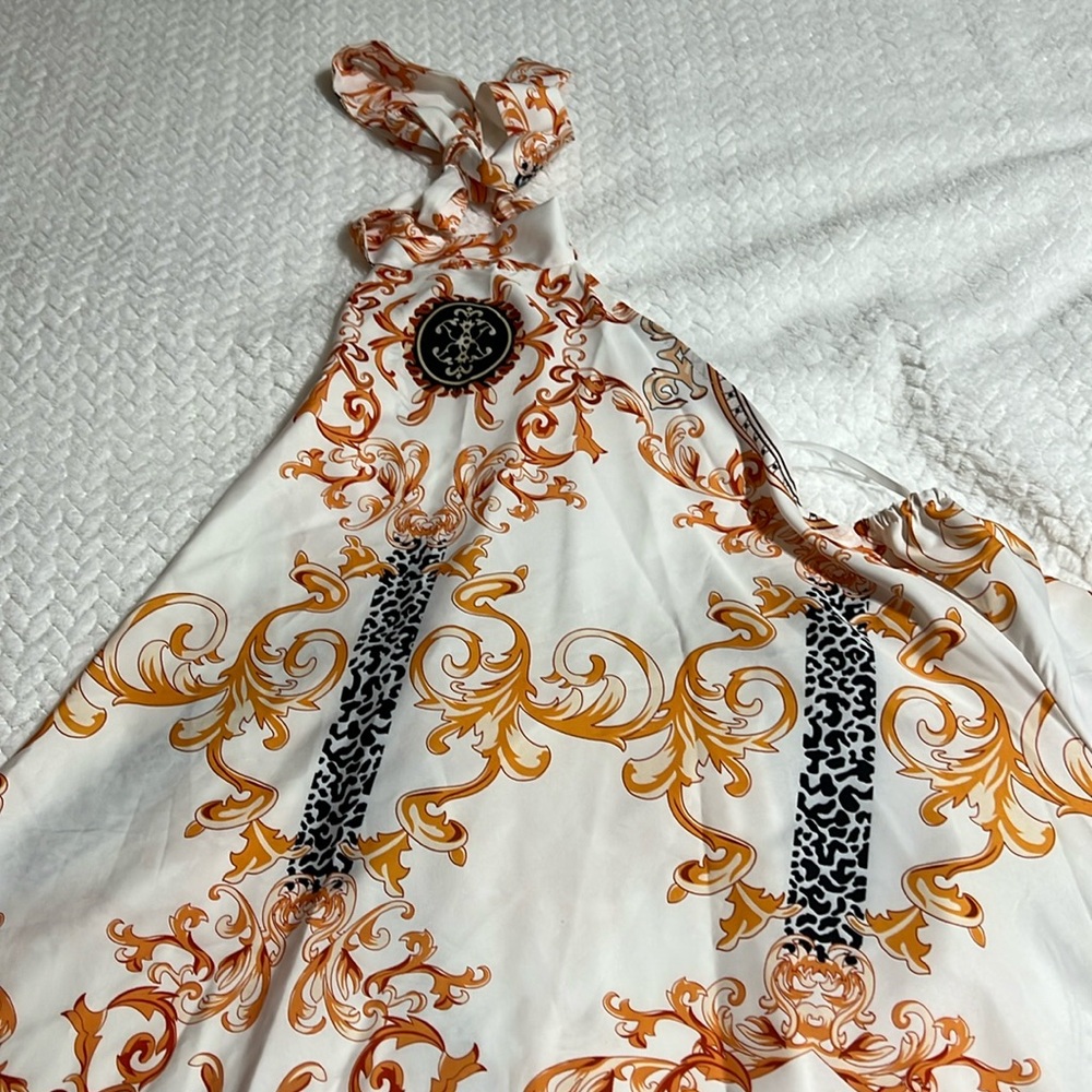 I am selling a maxi dress, gold and black and white casual size medium